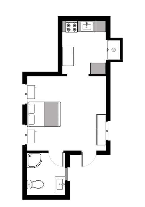 Sample floorplan of single-story 600 square foot ADU with one bedroom, one bathroom, and one kitchen. The unit is irregularly shaped. The upper portion is a kitchen. The central portion is the bedroom/living area. The bottom portion is the bathroom with space for a shower. There is one entrance into the bedroom/living area.