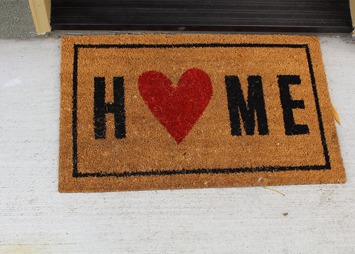 Doormat with Home written on it.
