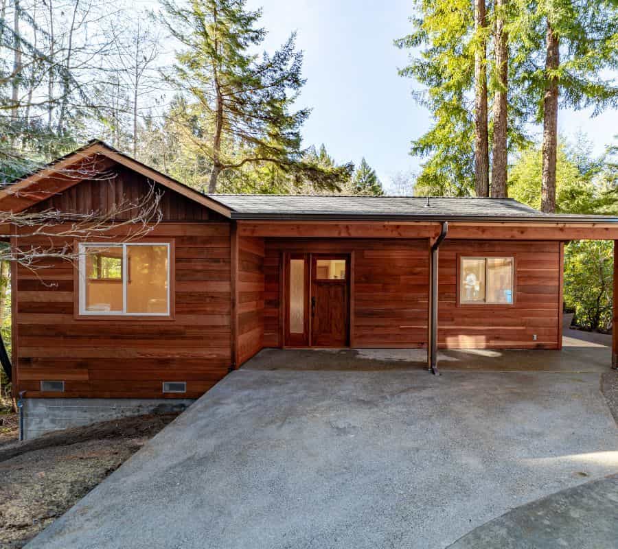 An ADU with a covered porch and driveway.